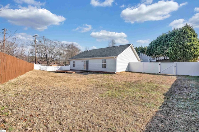 rear view of property featuring a lawn