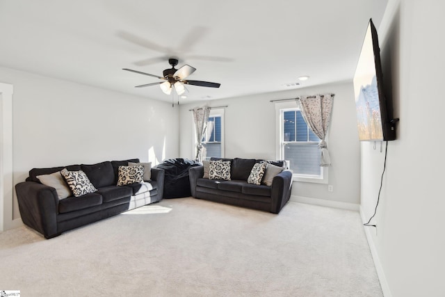 carpeted living room featuring ceiling fan