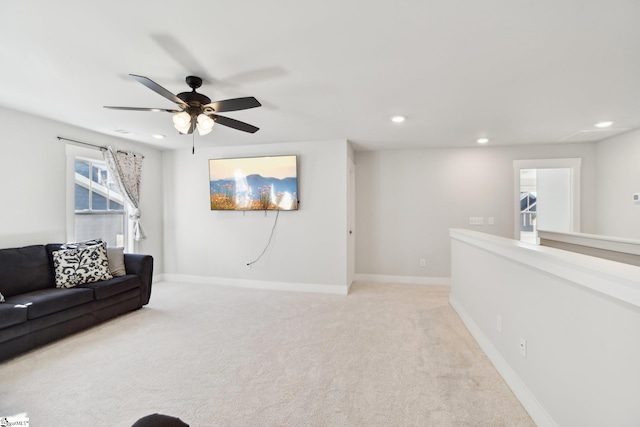 carpeted living room featuring ceiling fan