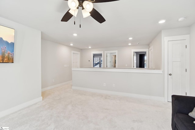 empty room with ceiling fan and light colored carpet