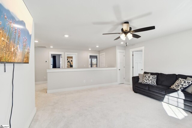 living room featuring light carpet and ceiling fan