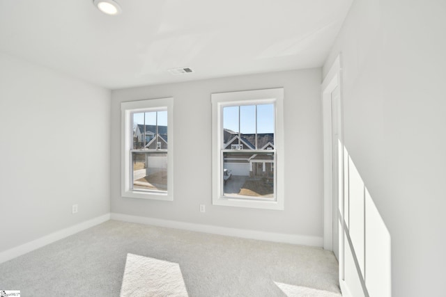 empty room featuring light carpet