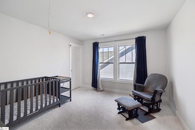 carpeted bedroom with a crib