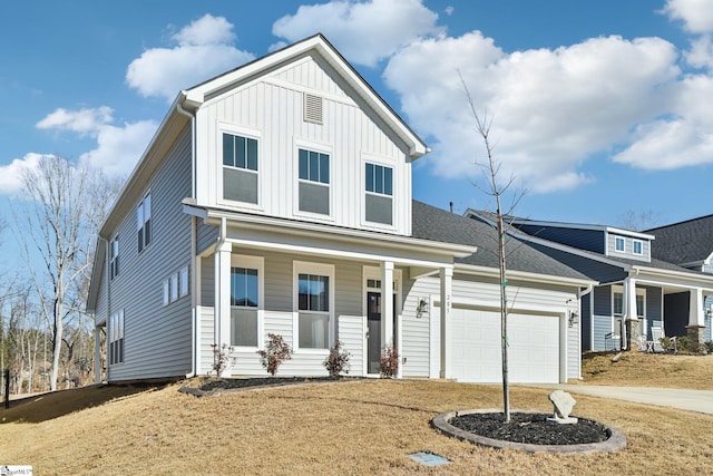 view of front facade with a garage, a front yard, and covered porch