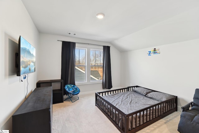 carpeted bedroom with vaulted ceiling