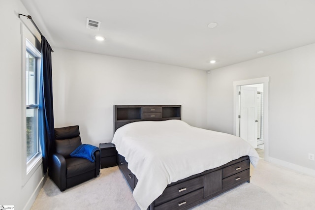 bedroom featuring light colored carpet