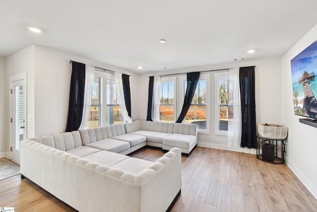 living room with a healthy amount of sunlight and light wood-type flooring