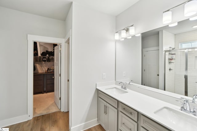 bathroom with vanity, an enclosed shower, and hardwood / wood-style floors