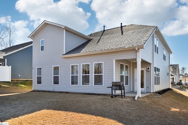 rear view of house featuring a patio and a lawn