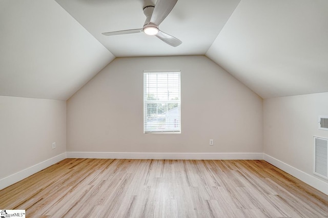 additional living space with vaulted ceiling, ceiling fan, and light wood-type flooring