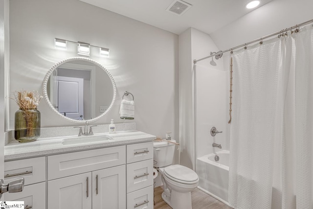 full bathroom with vanity, hardwood / wood-style floors, toilet, and shower / bath combo with shower curtain