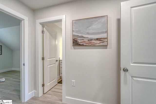 corridor with light hardwood / wood-style flooring