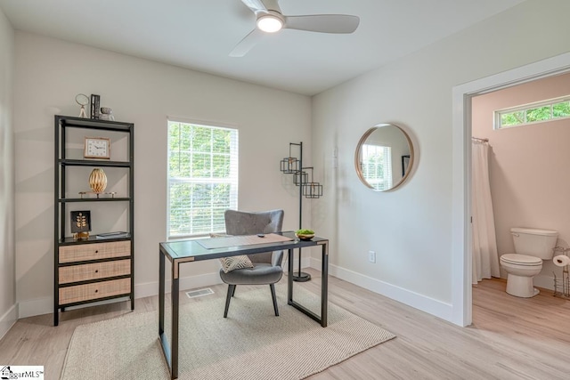 office with light hardwood / wood-style floors and ceiling fan