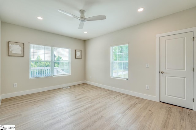 empty room featuring ceiling fan and light hardwood / wood-style floors