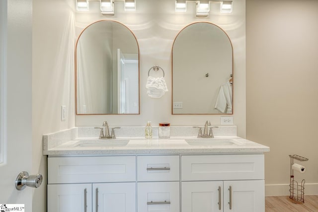 bathroom with vanity and hardwood / wood-style floors