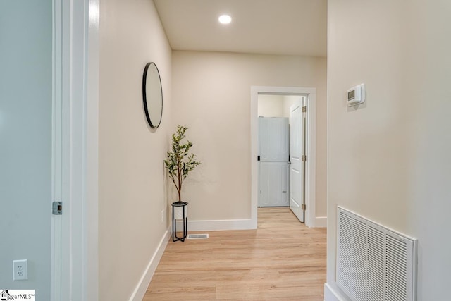 hallway with light hardwood / wood-style flooring