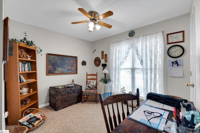 office with ceiling fan and a textured ceiling