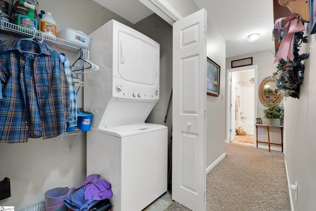 laundry room featuring stacked washing maching and dryer and a textured ceiling