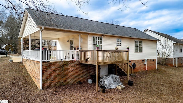 rear view of house featuring a wooden deck