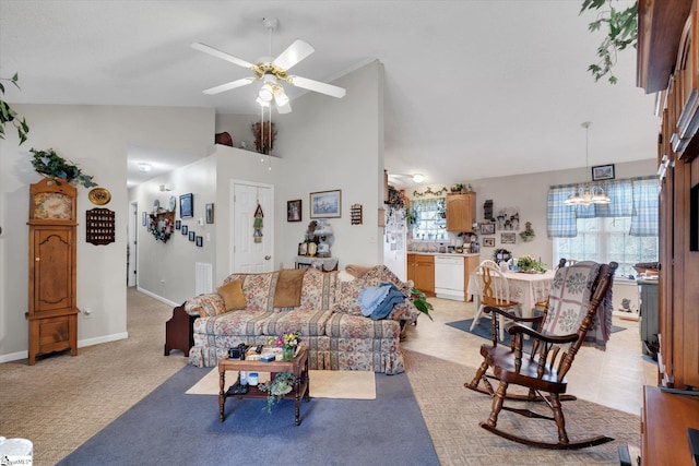 carpeted living room with lofted ceiling, a healthy amount of sunlight, and ceiling fan with notable chandelier