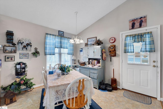 dining room featuring lofted ceiling and a chandelier