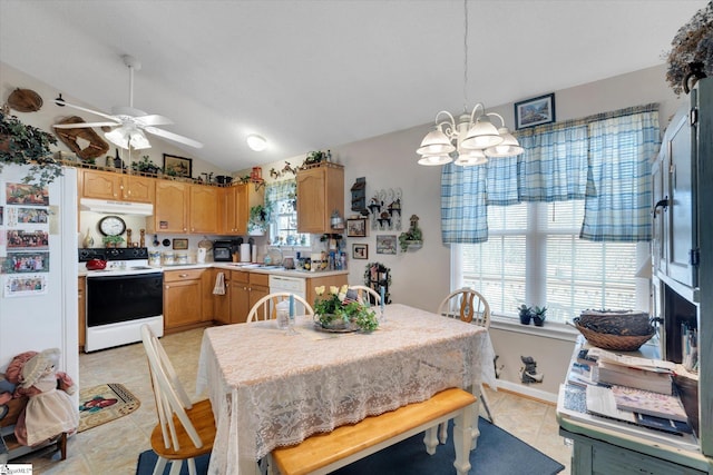 tiled dining room with vaulted ceiling, sink, and ceiling fan with notable chandelier