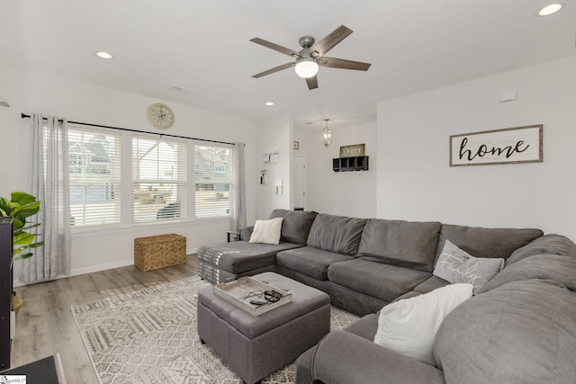 living room with ceiling fan and light hardwood / wood-style floors