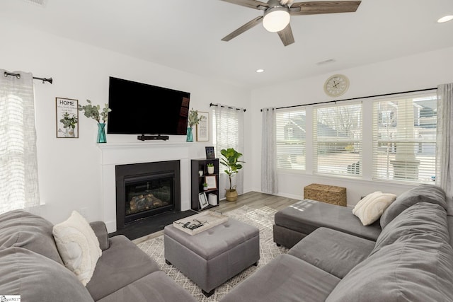 living room featuring ceiling fan and light hardwood / wood-style floors