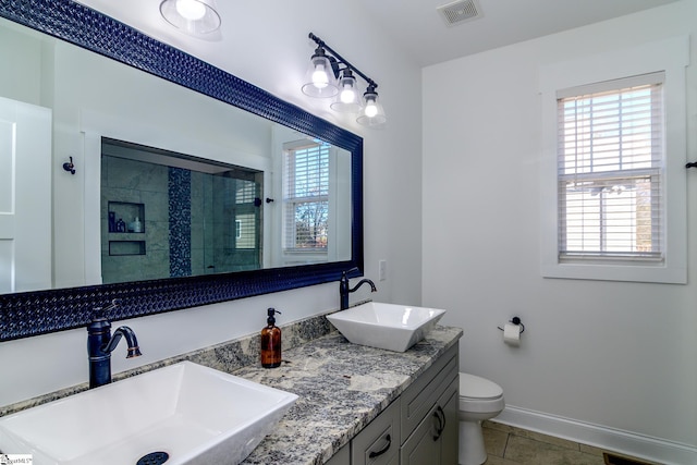 bathroom featuring tile patterned flooring, vanity, and toilet