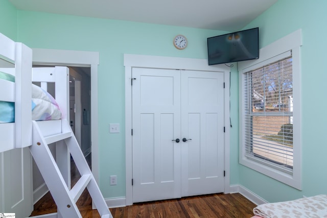 bedroom featuring dark hardwood / wood-style flooring and a closet