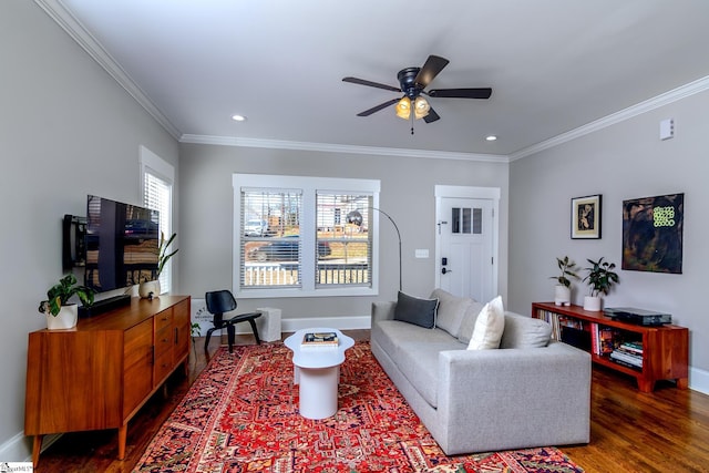 living room with dark wood-type flooring, ornamental molding, and ceiling fan