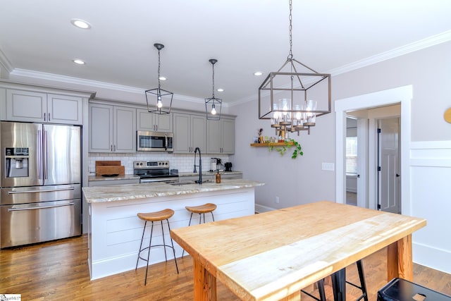 kitchen with tasteful backsplash, appliances with stainless steel finishes, gray cabinetry, and light stone counters