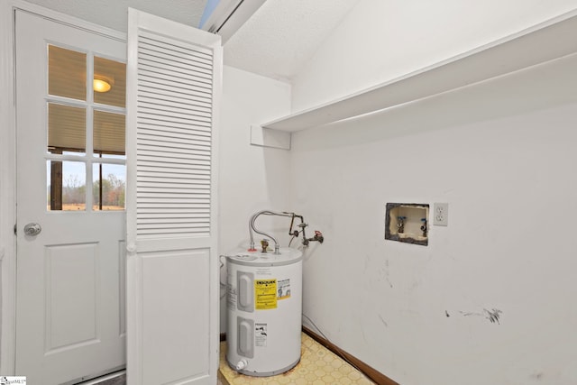 washroom featuring hookup for a washing machine, water heater, and a textured ceiling