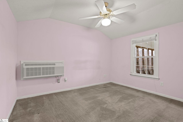 unfurnished room featuring lofted ceiling, a textured ceiling, an AC wall unit, carpet floors, and ceiling fan