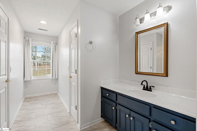 bathroom with vanity and a textured ceiling