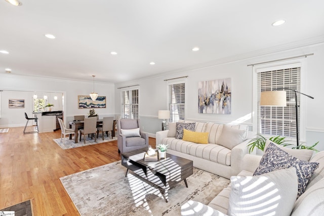 living room featuring ornamental molding and light wood-type flooring