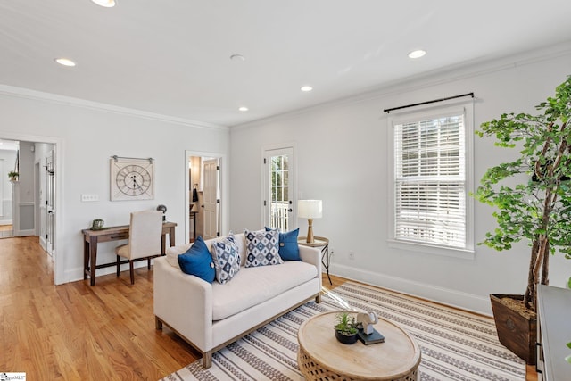 living room featuring ornamental molding and light hardwood / wood-style floors