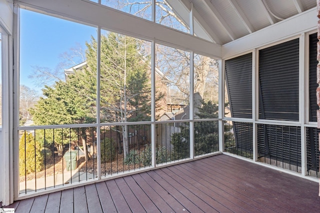 unfurnished sunroom featuring vaulted ceiling