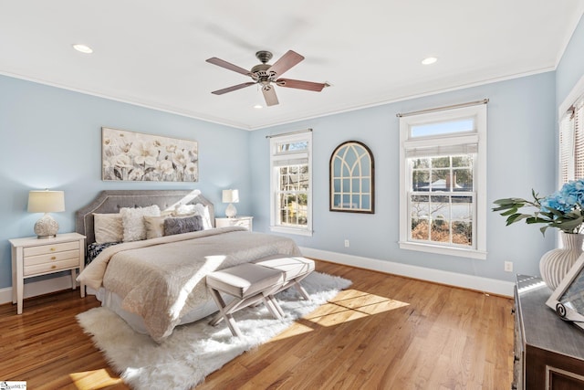 bedroom with hardwood / wood-style flooring, ceiling fan, and ornamental molding