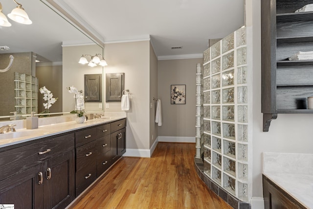 bathroom featuring hardwood / wood-style flooring, vanity, and crown molding