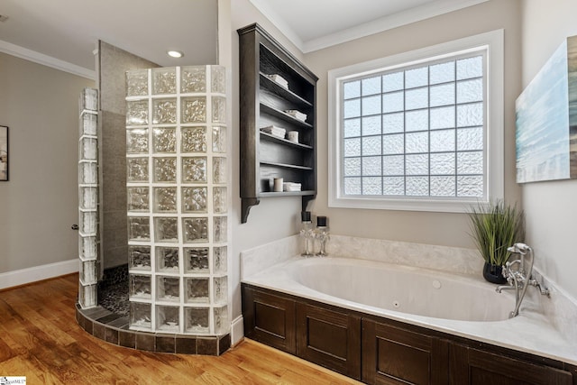 bathroom featuring crown molding, independent shower and bath, hardwood / wood-style floors, and a wealth of natural light