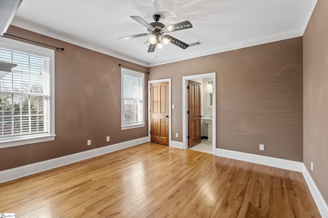 unfurnished bedroom featuring crown molding, ceiling fan, connected bathroom, and light hardwood / wood-style flooring