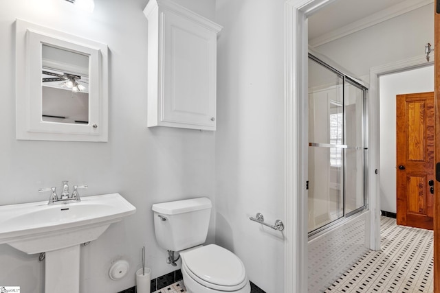 bathroom featuring combined bath / shower with glass door and toilet