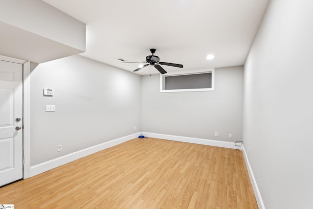 spare room with ceiling fan and light wood-type flooring