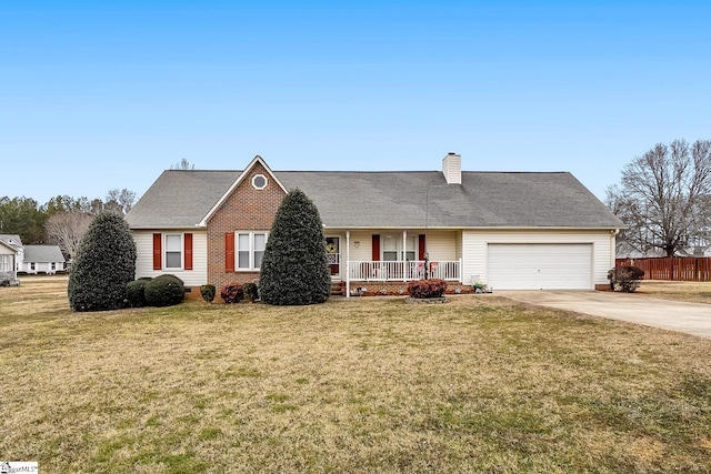 view of front of home featuring a garage, a front lawn, and covered porch