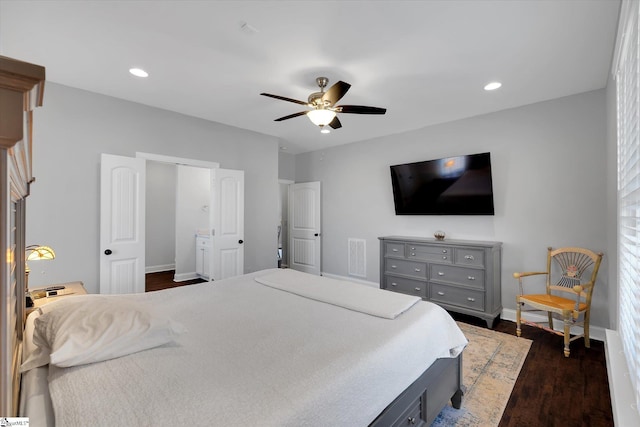 bedroom with dark hardwood / wood-style flooring and ceiling fan