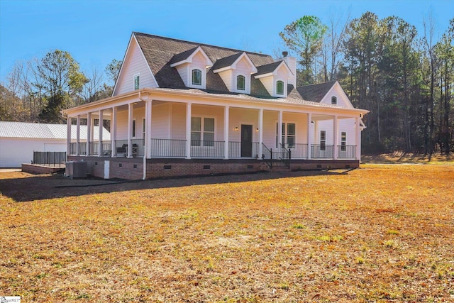 country-style home with a front yard, covered porch, and central air condition unit