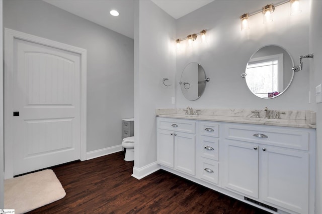 bathroom featuring hardwood / wood-style flooring, vanity, and toilet