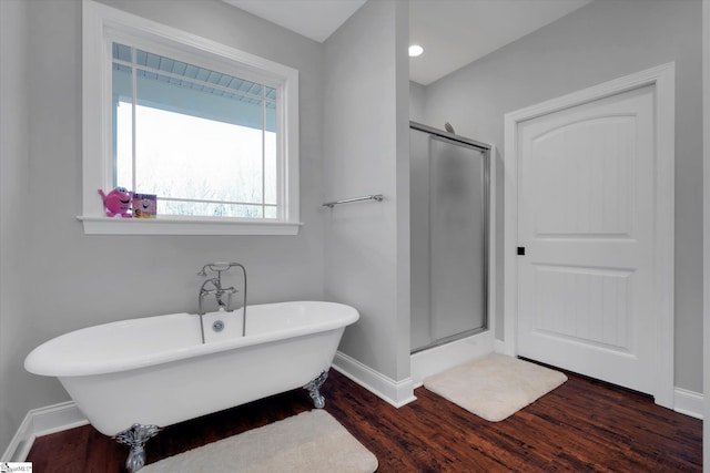 bathroom with hardwood / wood-style floors and plus walk in shower