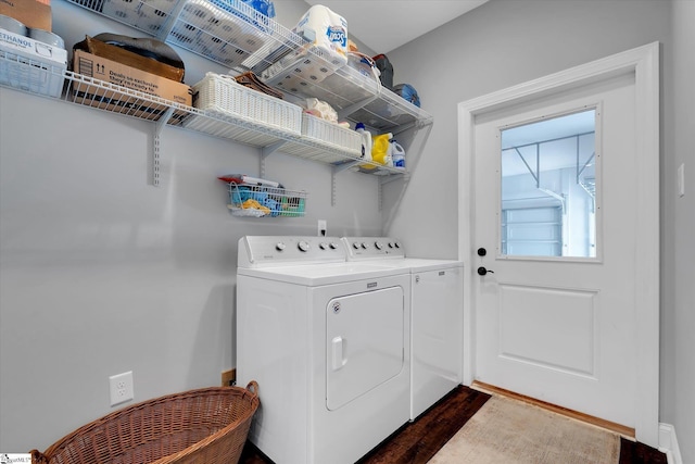 laundry area featuring separate washer and dryer and dark hardwood / wood-style floors